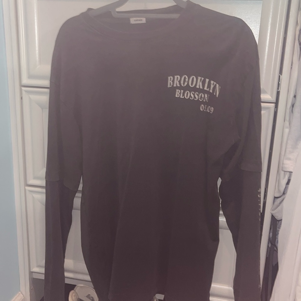 grey long sleeve from garage with pattern on back.